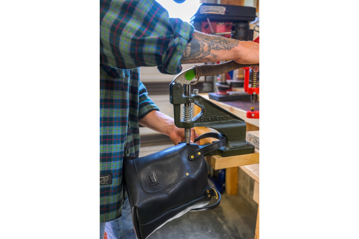 Fastening a strap to a bag.