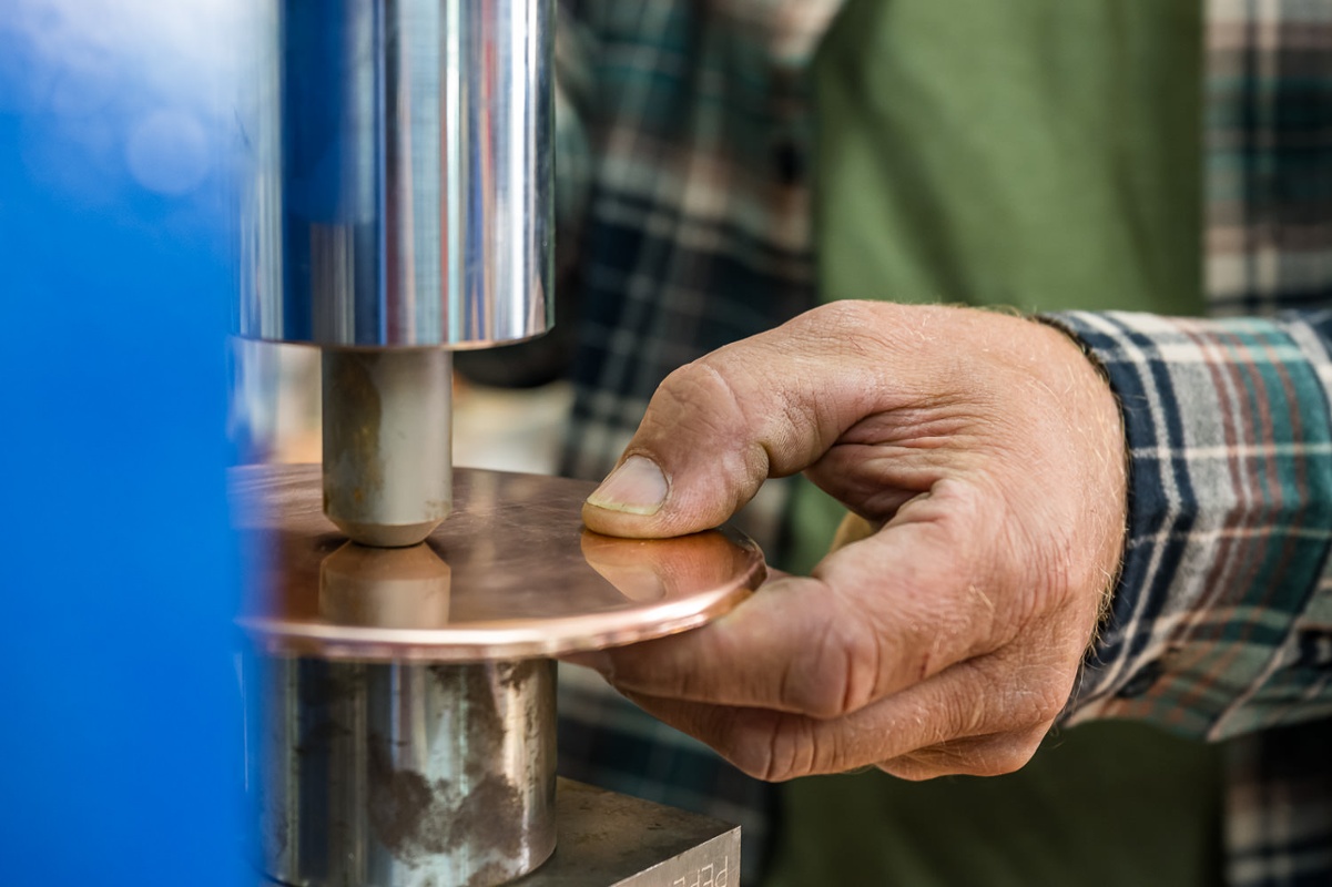 Stamping a maker's mark.